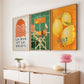 Three colorful framed artworks on a wall above a wooden console table.