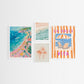 Set of four framed beach-themed artworks on a white wall