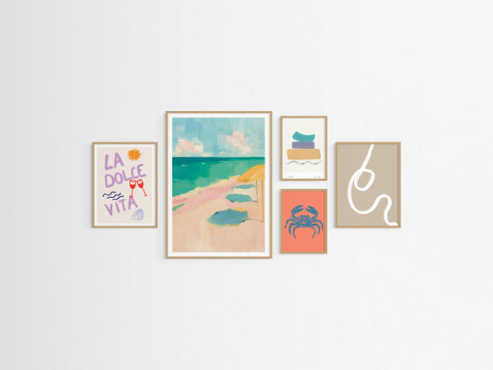 Five framed beach themed artworks on a white wall